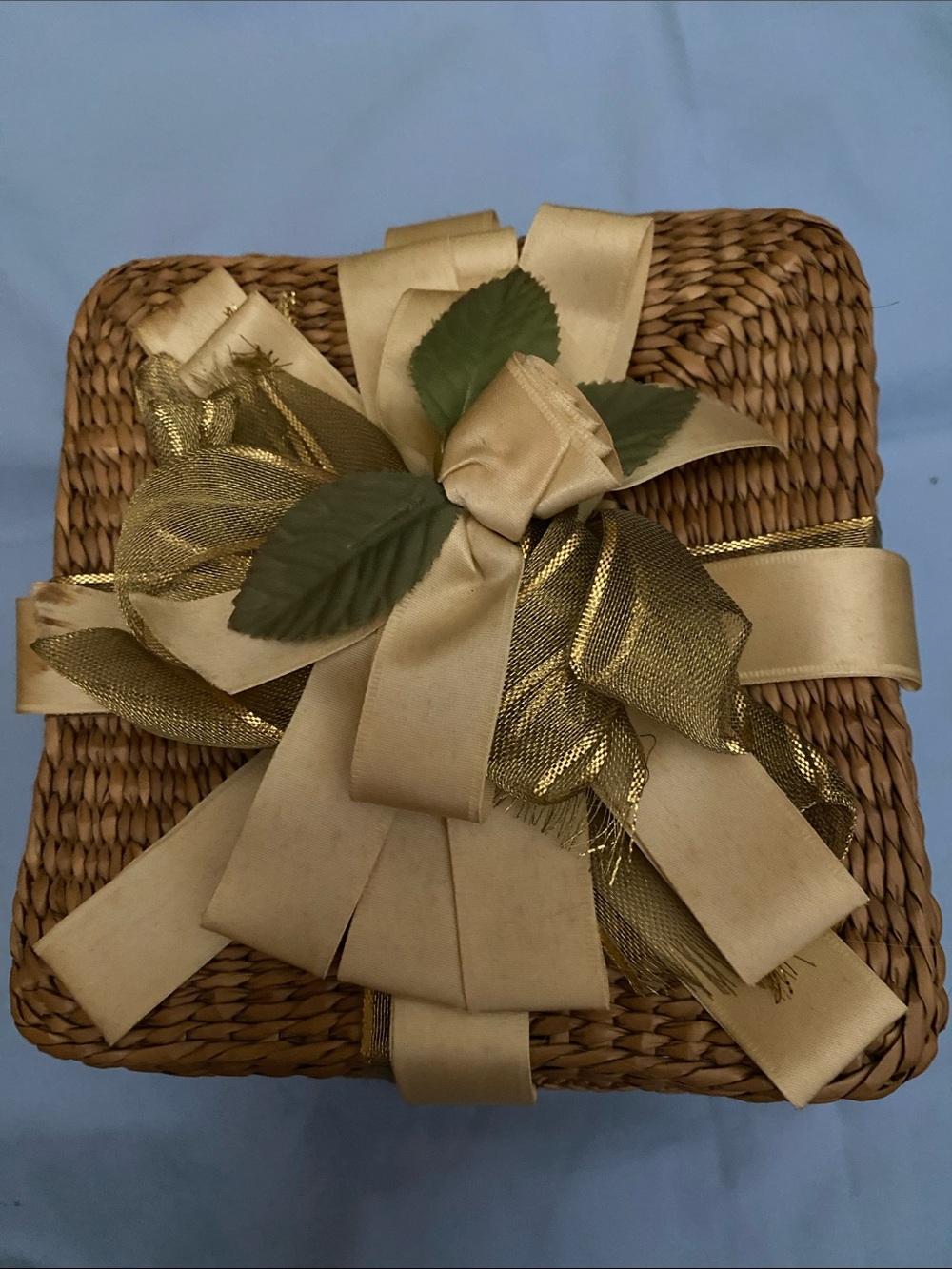 Woven Gift Basket with Gold Ribbon and Faux Green Leaves